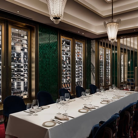 Restaurant dining space with green walls and wine fridge in Don's Prime