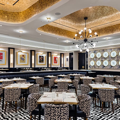 Tables and chairs under lighting fixtures in Vida