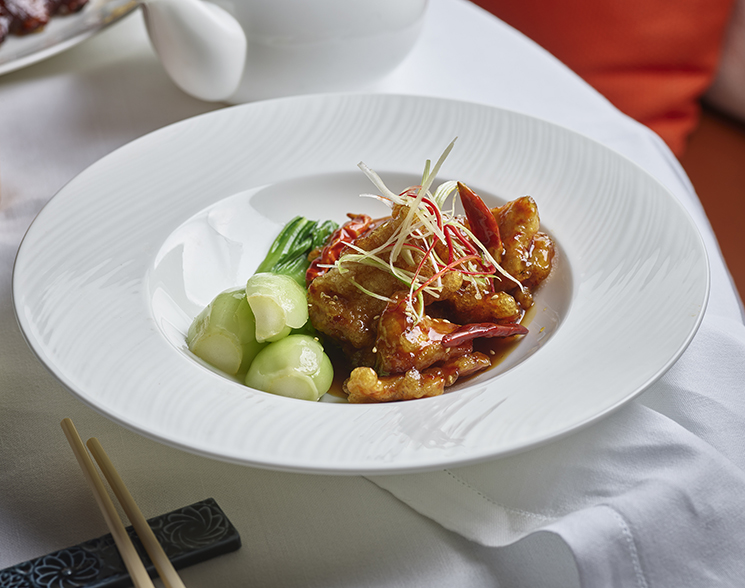 Meat and vegetables on a white plate with rice from Chyna Club restaurant