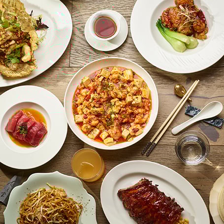 Six plates of food with utensils and dipping sauces from Chyna Club