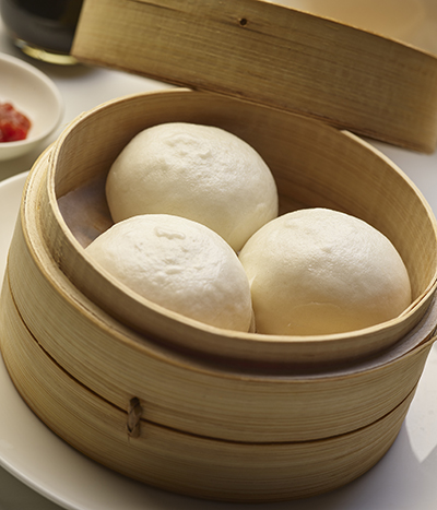 Steamed buns in a wooden container