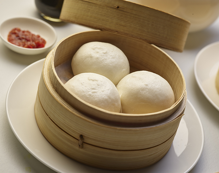 Steamed buns in a wooden container