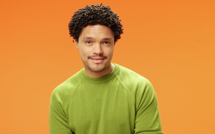 Comedian Trevor Noah against orange background