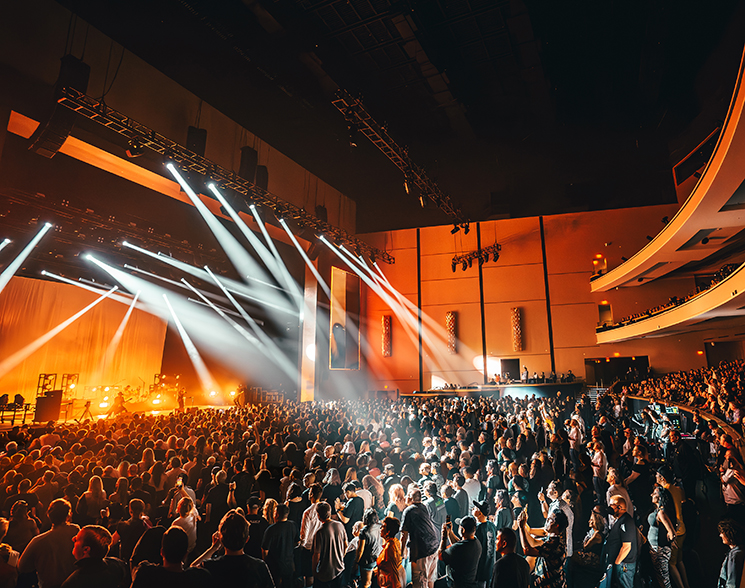 Crowded theater lit from a performance