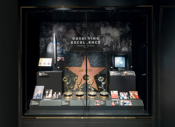 Museum display of awards including Emmys, Hollywood star and more.