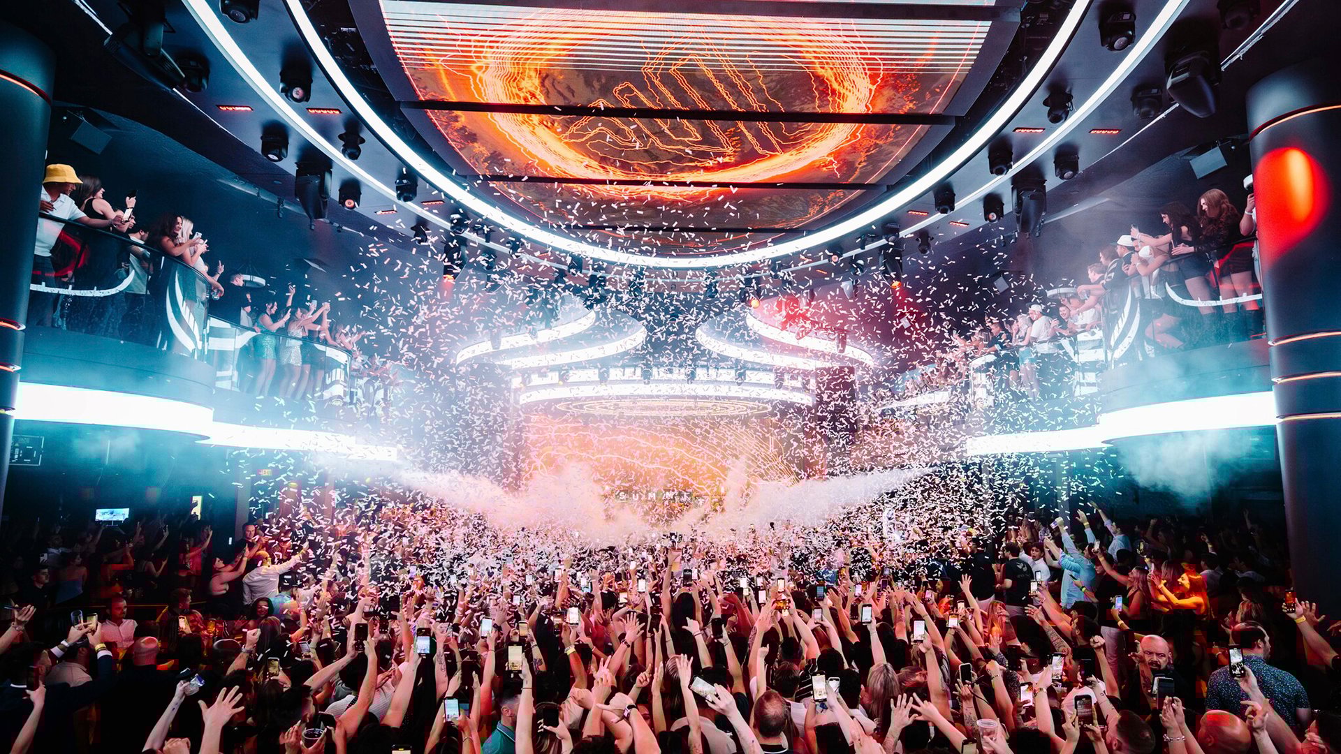 Crowd under LED screen with confetti