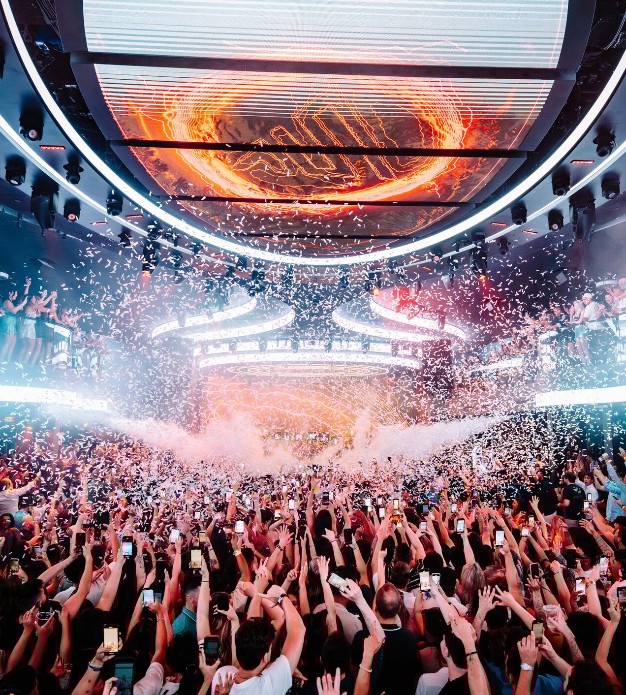 Crowd under LED screen with confetti