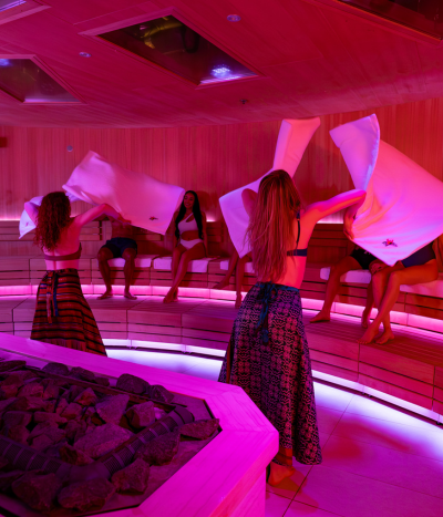 2 performers with towels in front of a seated audience