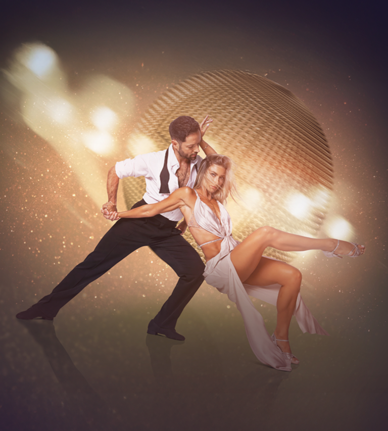 Pair of dancers posing in front of disco ball