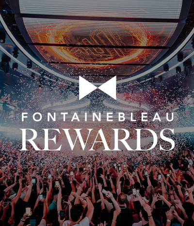 Crowded club with confetti under LED halo under text: Fontainebleau Rewards