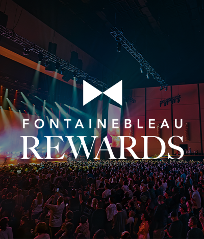 Crowded theater watching a show under text: Fontainebleau Rewards