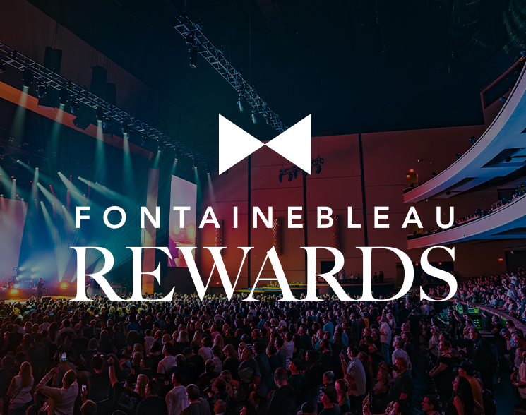 Crowded theater watching a show under text: Fontainebleau Rewards