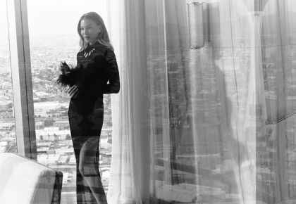 Model in black dress in front of window with black box and white text: No Resort Fees