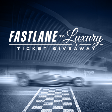 F1 car blurred over a finish line under text: Fastlane to Luxury ticket giveaway