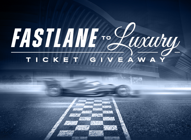 F1 car blurred over a finish line under text: Fastlane to Luxury ticket giveaway