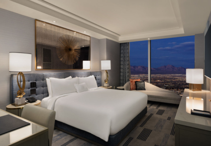 Bed next to sitting area with view of mountains