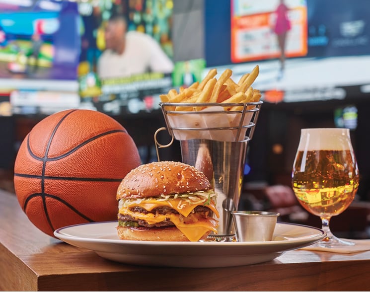 Basketball behind cheeseburger, fries and beer at The Tavern at Fontainebleau Las Vegas