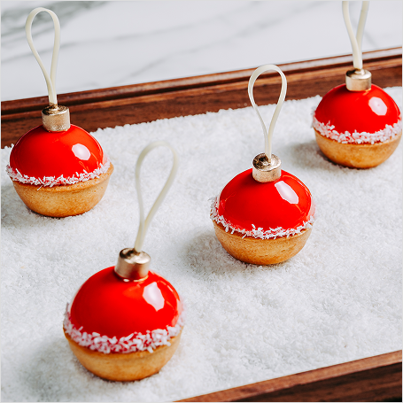 Sweets shaped like ornaments on sugar bed