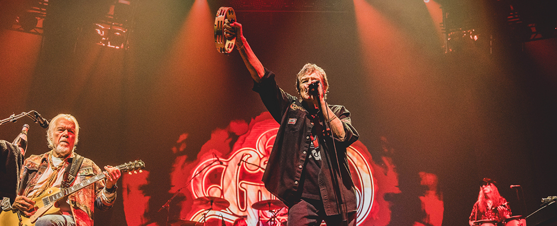 The Guess Who performing in red lighting