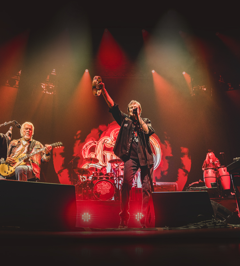 The Guess Who performing in red lighting